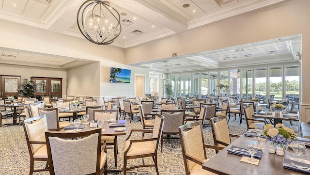 dining area with french doors, a notable chandelier, ornamental molding, coffered ceiling, and beamed ceiling