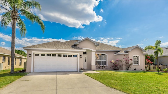 ranch-style house featuring stucco siding, concrete driveway, a front yard, fence, and a garage