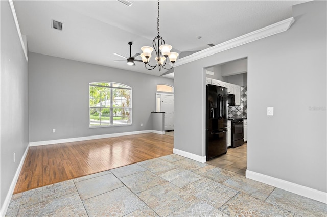 unfurnished dining area with baseboards, visible vents, stone tile floors, and an inviting chandelier