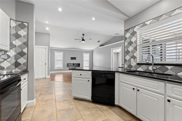 kitchen with a ceiling fan, dark countertops, vaulted ceiling, black appliances, and a sink