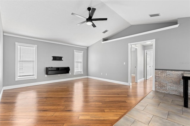 unfurnished living room featuring vaulted ceiling, ceiling fan, wood finished floors, and visible vents