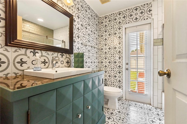 bathroom featuring tile patterned flooring, plenty of natural light, vanity, and toilet