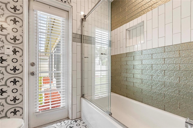 bathroom featuring plenty of natural light and enclosed tub / shower combo