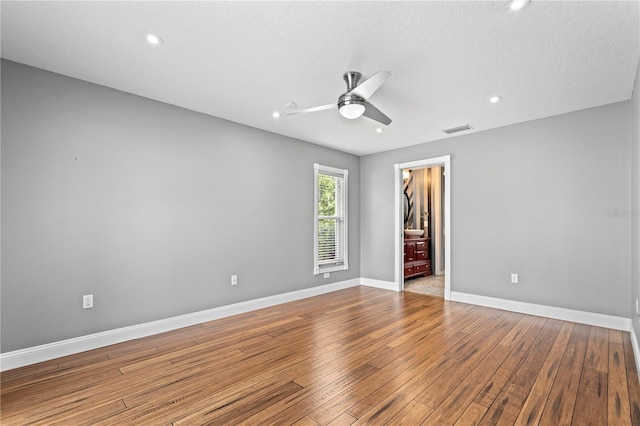 spare room featuring ceiling fan, recessed lighting, visible vents, baseboards, and wood-type flooring