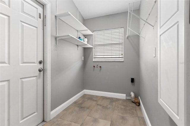 laundry area with hookup for an electric dryer, laundry area, washer hookup, baseboards, and tile patterned floors