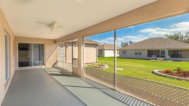 unfurnished sunroom with a ceiling fan