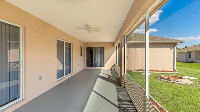 view of patio / terrace with an outdoor fire pit and a ceiling fan