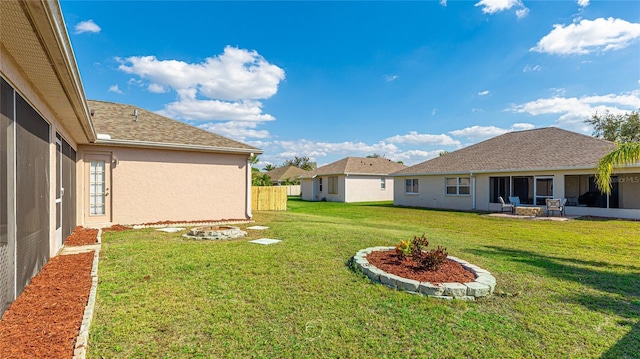 view of yard with an outdoor fire pit and fence