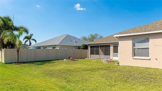 view of yard featuring a sunroom and fence