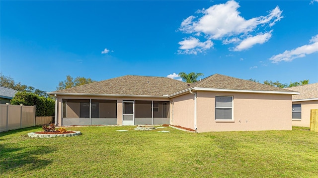 rear view of house featuring a sunroom, a fenced backyard, a lawn, and stucco siding