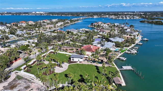 drone / aerial view with a water view and a residential view