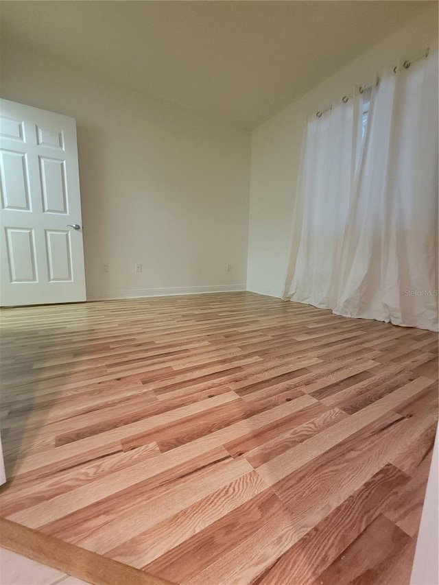 unfurnished room featuring light wood-style floors