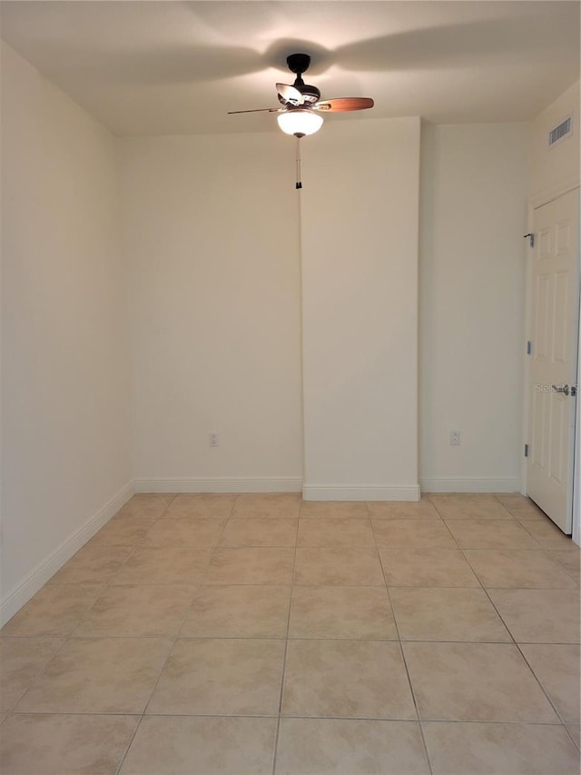 empty room featuring baseboards, visible vents, and light tile patterned flooring