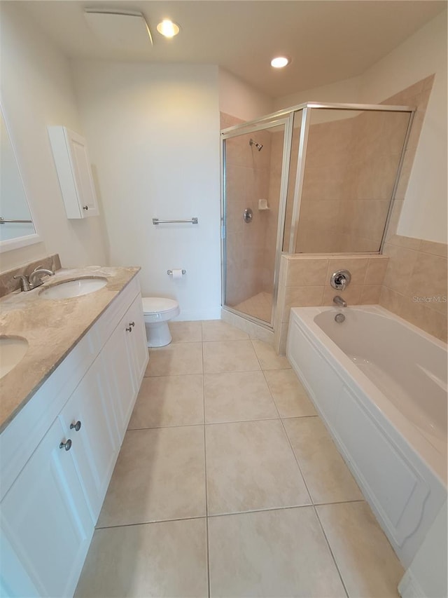 full bath featuring a garden tub, toilet, a stall shower, a sink, and tile patterned floors