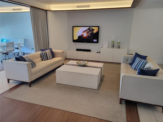 living room with visible vents and wood finished floors