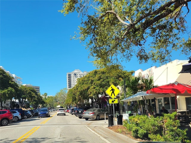 view of road featuring traffic signs and curbs