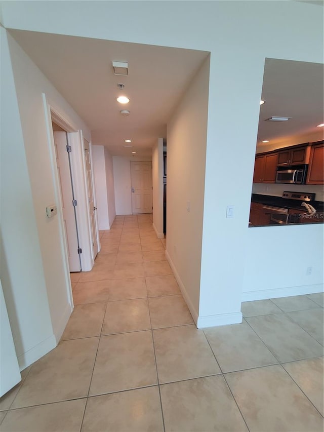 1771 Ringling Blvd Unit 902, Sarasota, FL 34236 - corridor with light tile patterned floors, recessed lighting, and baseboards
