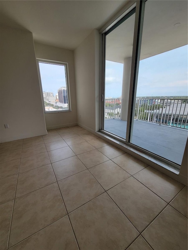 1771 Ringling Blvd Unit 902, Sarasota, FL 34236 - spare room with plenty of natural light and light tile patterned floors