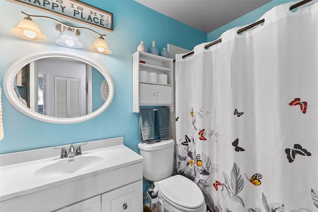 bathroom with vanity, toilet, and a shower with curtain