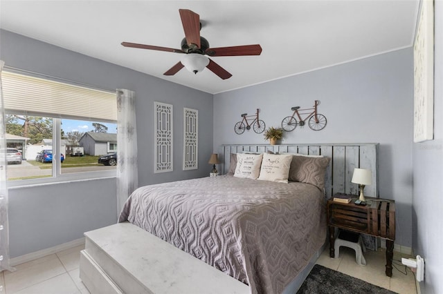 bedroom with tile patterned flooring, baseboards, and ceiling fan