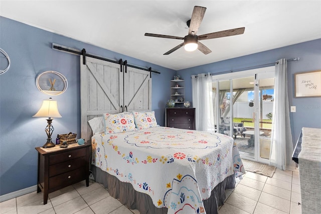 tiled bedroom with access to exterior, a barn door, baseboards, and ceiling fan