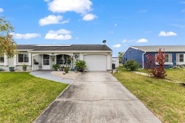 ranch-style house with solar panels, a front yard, an attached garage, and stucco siding