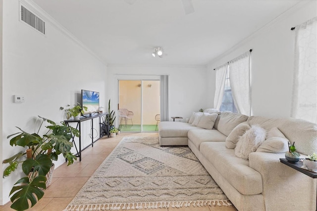 living room featuring ornamental molding, visible vents, and light tile patterned floors