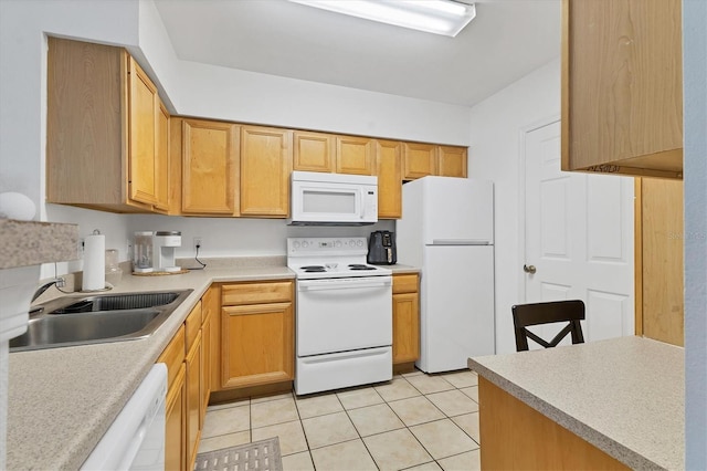 kitchen with white appliances, light tile patterned floors, light countertops, and a sink