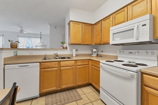 kitchen with white appliances, light tile patterned floors, light countertops, and a sink