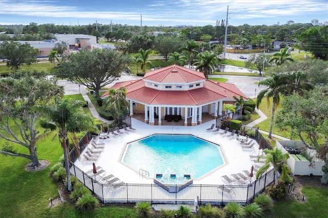 community pool featuring a patio and fence