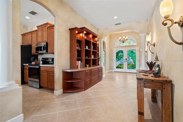 kitchen featuring open shelves, arched walkways, stainless steel appliances, and french doors