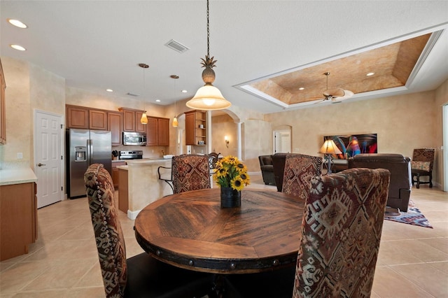 dining area with arched walkways, light tile patterned flooring, ceiling fan, and recessed lighting