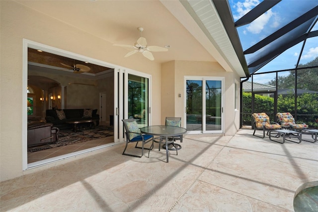 view of patio / terrace featuring a lanai, ceiling fan, and outdoor dining space