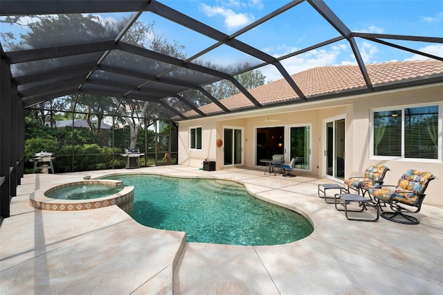 view of swimming pool with ceiling fan, a patio, glass enclosure, a grill, and a pool with connected hot tub