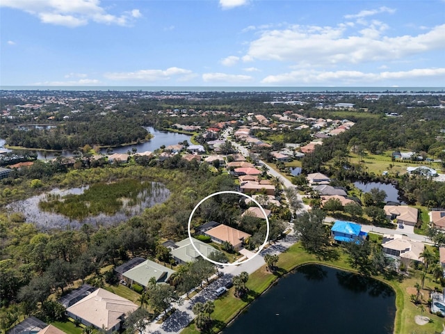 birds eye view of property with a water view