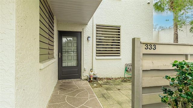 doorway to property with stucco siding