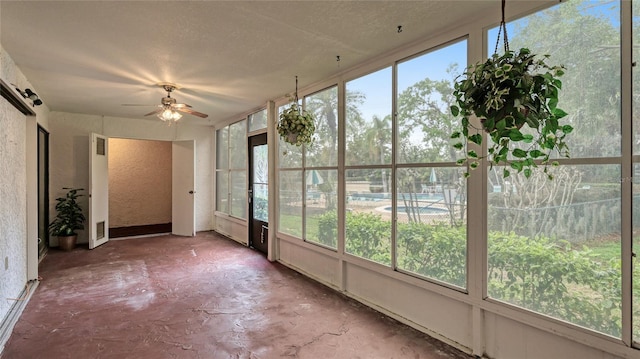 unfurnished sunroom with ceiling fan