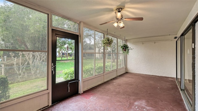 unfurnished sunroom featuring plenty of natural light and ceiling fan