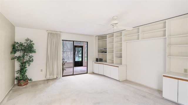 spare room featuring ceiling fan and light colored carpet