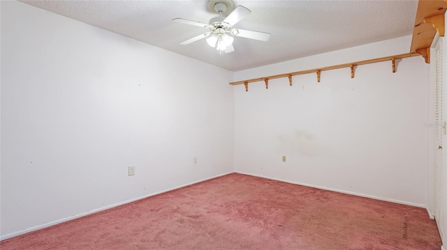 empty room featuring a textured ceiling, ceiling fan, carpet flooring, and baseboards