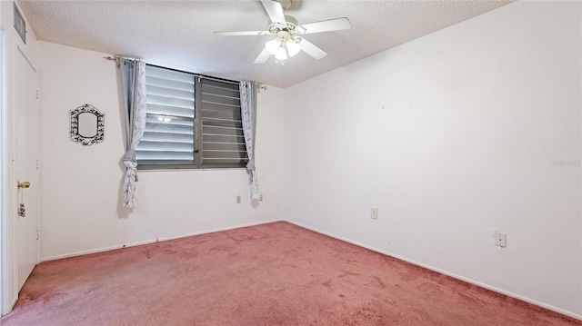 carpeted empty room with a textured ceiling, ceiling fan, and baseboards