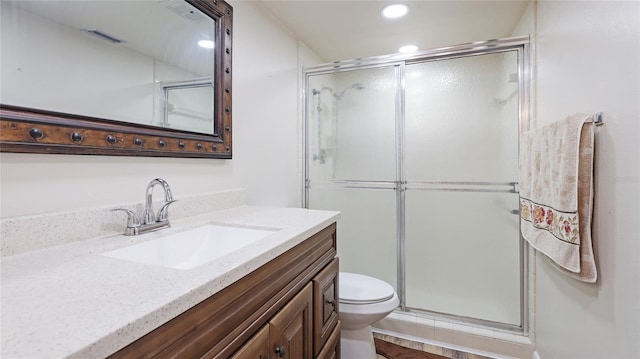 bathroom featuring a stall shower, visible vents, vanity, and toilet