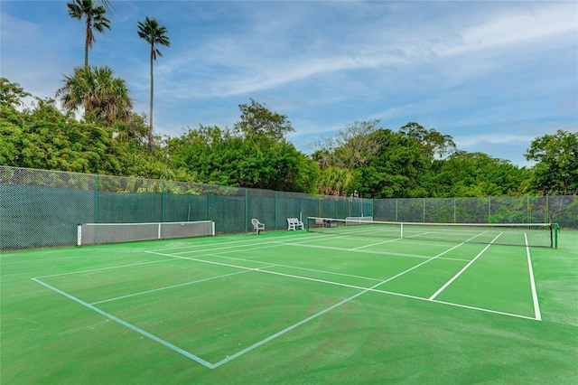 view of sport court featuring fence