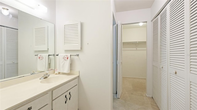 bathroom with a closet and vanity