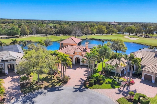 birds eye view of property with a water view and golf course view