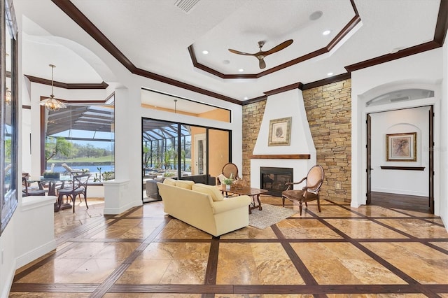 living area with crown molding, a raised ceiling, baseboards, and a sunroom