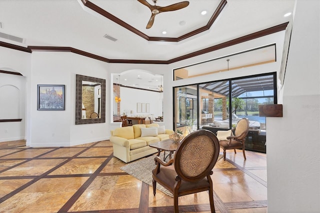 living room with arched walkways, marble finish floor, baseboards, and ornamental molding