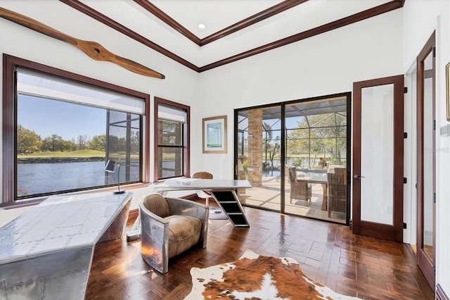 living area with baseboards, a towering ceiling, and ornamental molding