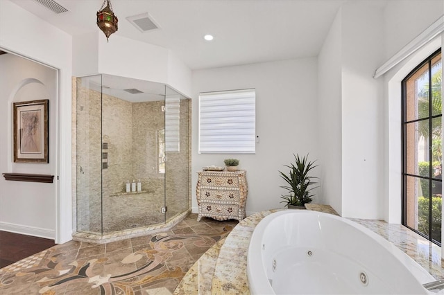 bathroom with visible vents, a stall shower, a jetted tub, and stone finish flooring