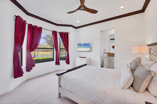 carpeted bedroom featuring a ceiling fan, baseboards, recessed lighting, ensuite bathroom, and crown molding